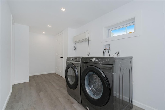 3553 Hylan Blvd, Staten Island, NY 10308 - laundry area with washer and clothes dryer, light wood-style flooring, baseboards, and a wall unit AC