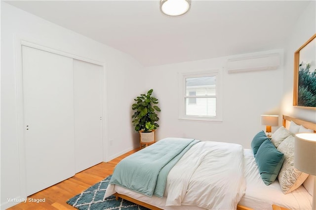 3553 Hylan Blvd, Staten Island, NY 10308 - bedroom featuring a wall mounted AC, light wood-style floors, vaulted ceiling, and a closet