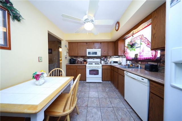 53 Marisa Cir, Staten Island, NY 10309 - kitchen featuring white appliances, backsplash, brown cabinets, ceiling fan, and tile countertops