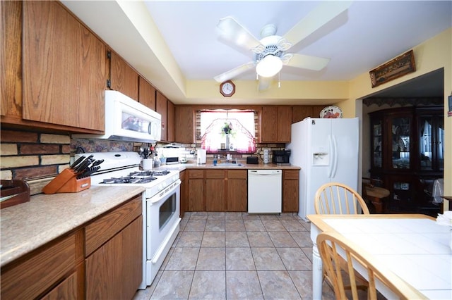 53 Marisa Cir, Staten Island, NY 10309 - kitchen featuring white appliances, tasteful backsplash, brown cabinets, light countertops, and ceiling fan