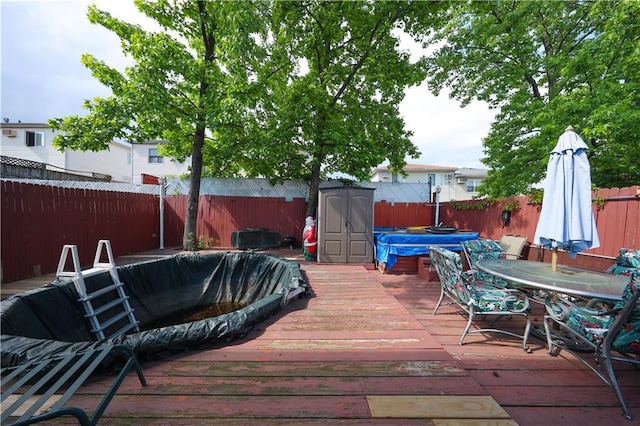 53 Marisa Cir, Staten Island, NY 10309 - deck with a fenced backyard, a storage shed, and outdoor dining area