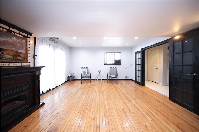53 Marisa Cir, Staten Island, NY 10309 - exercise area with a fireplace, light wood finished floors, recessed lighting, and french doors