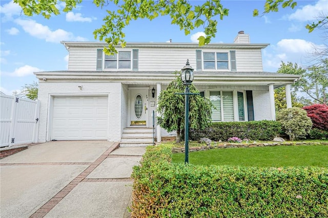 284 Todt Hill Rd, Staten Island, NY 10314 - traditional home featuring brick siding, a chimney, a gate, an attached garage, and concrete driveway
