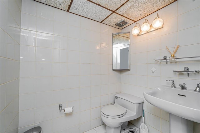 284 Todt Hill Rd, Staten Island, NY 10314 - bathroom featuring tile walls, toilet, and a sink