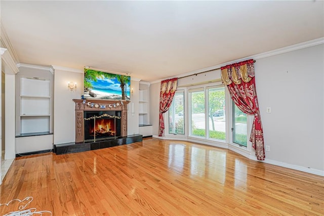 284 Todt Hill Rd, Staten Island, NY 10314 - unfurnished living room featuring wood finished floors, ornamental molding, a fireplace, and built in shelves