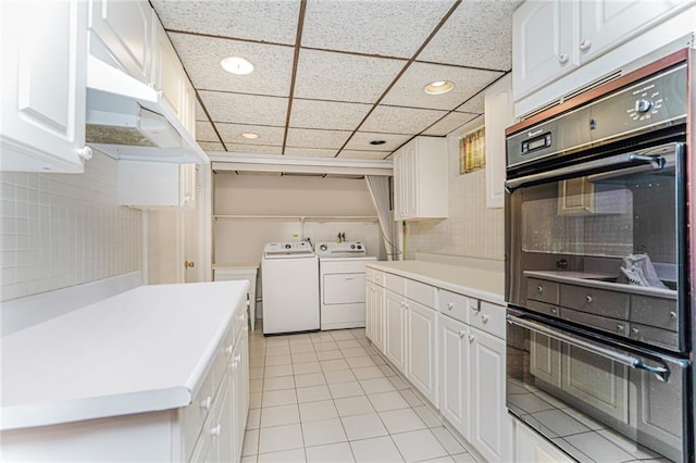 284 Todt Hill Rd, Staten Island, NY 10314 - kitchen with washer and clothes dryer, recessed lighting, light tile patterned flooring, white cabinets, and light countertops