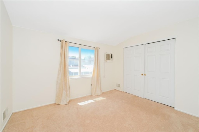 88 Jumel St, Staten Island, NY 10308 - unfurnished bedroom with light colored carpet, an AC wall unit, vaulted ceiling, and a closet