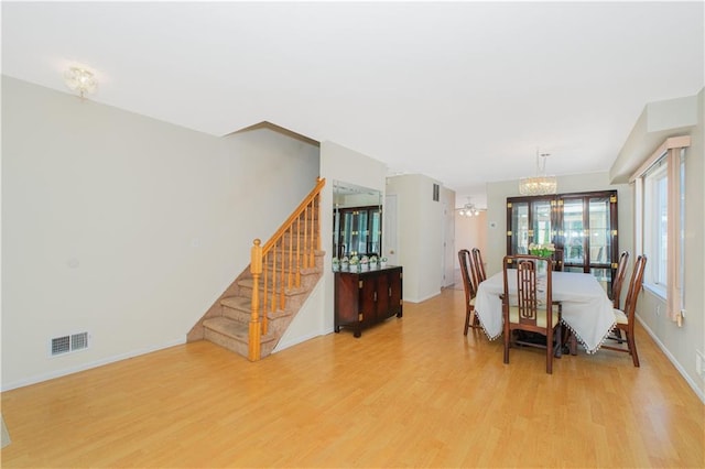 88 Jumel St, Staten Island, NY 10308 - dining room with light wood-style floors, a chandelier, and stairs