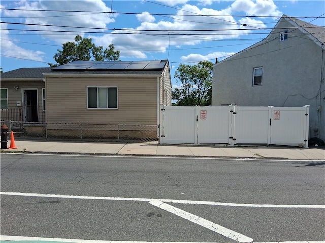 483 Van Duzer St, Staten Island, NY 10301 - view of front of home with a gate and solar panels
