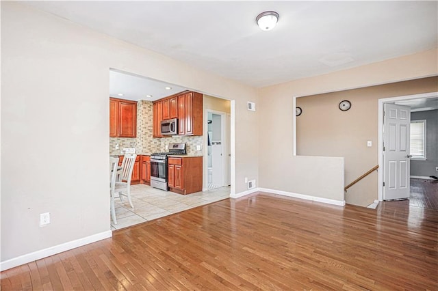 483 Van Duzer St, Staten Island, NY 10301 - unfurnished living room featuring light wood finished floors and baseboards