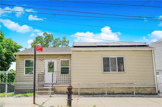 483 Van Duzer St, Staten Island, NY 10301 - view of front of house featuring solar panels and a fenced front yard