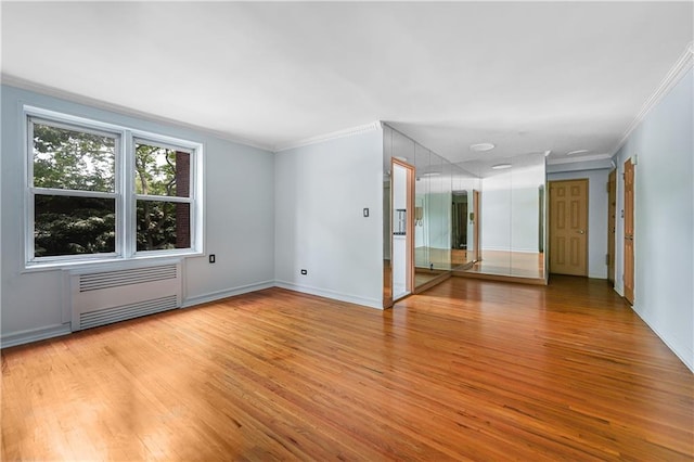 394 Avenue S Unit 2E, Brooklyn, NY 11223 - spare room featuring radiator heating unit, light wood finished floors, crown molding, and baseboards