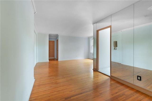 394 Avenue S Unit 2E, Brooklyn, NY 11223 - empty room featuring light wood-style flooring, baseboards, and crown molding