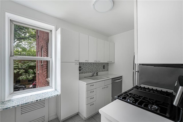 394 Avenue S Unit 2E, Brooklyn, NY 11223 - kitchen featuring stainless steel dishwasher, a sink, light countertops, range with gas cooktop, and tasteful backsplash