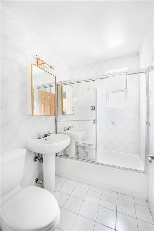 394 Avenue S Unit 2E, Brooklyn, NY 11223 - bathroom with toilet, bath / shower combo with glass door, and tile patterned flooring