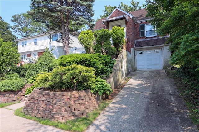 50 Glenwood Ave, Staten Island, NY 10301 - view of front of house featuring driveway, an attached garage, brick siding, and a shingled roof
