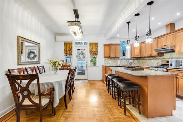 880 Bay Ridge Ave, Brooklyn, NY 11220 - kitchen with under cabinet range hood, stainless steel range oven, a wall mounted air conditioner, backsplash, and crown molding