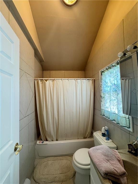 520 Clermont Ave, Staten Island, NY 10307 - bathroom with vaulted ceiling, toilet, vanity, shower / bath combo, and tile walls