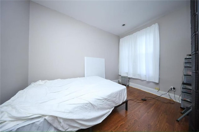 8669 15th Ave, Brooklyn, NY 11228 - bedroom featuring radiator heating unit and wood finished floors