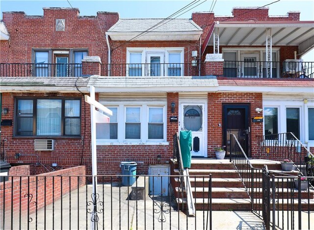 8669 15th Ave, Brooklyn, NY 11228 - view of property featuring brick siding and a fenced front yard