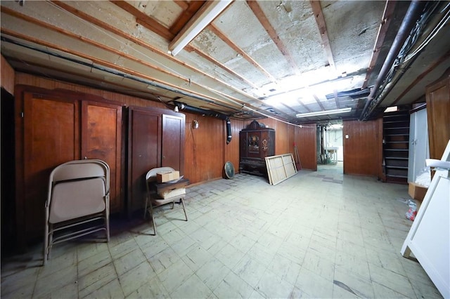 8669 15th Ave, Brooklyn, NY 11228 - basement featuring light floors, wood walls, and stairs