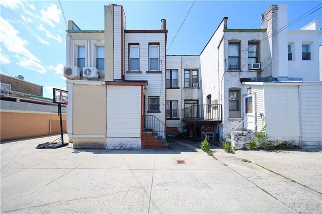 8669 15th Ave, Brooklyn, NY 11228 - rear view of property featuring entry steps and cooling unit