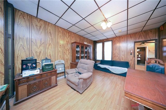 8669 15th Ave, Brooklyn, NY 11228 - living room with wooden walls, a paneled ceiling, and wood finished floors