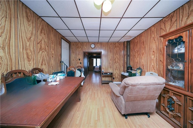 8669 15th Ave, Brooklyn, NY 11228 - living room with wood walls, a drop ceiling, and wood finished floors