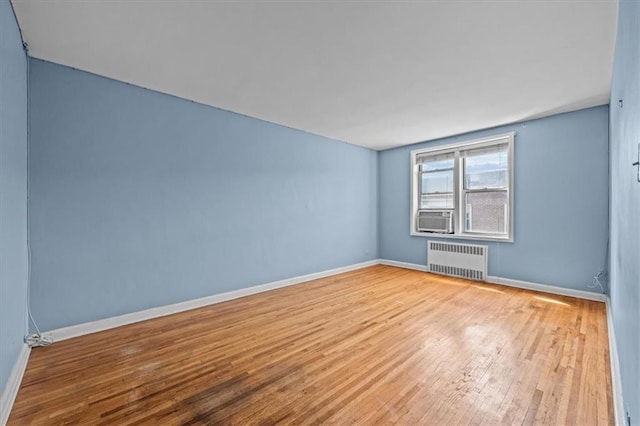 221 Mcdonald Ave Unit 6R, Brooklyn, NY 11218 - unfurnished room with radiator heating unit, wood finished floors, baseboards, and cooling unit