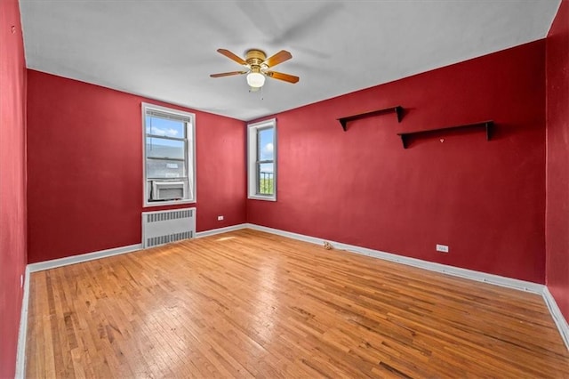221 Mcdonald Ave Unit 6R, Brooklyn, NY 11218 - spare room with radiator heating unit, a ceiling fan, hardwood / wood-style flooring, and baseboards