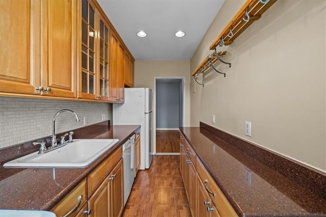 221 Mcdonald Ave Unit 6R, Brooklyn, NY 11218 - kitchen featuring a sink, brown cabinets, tasteful backsplash, glass insert cabinets, and recessed lighting