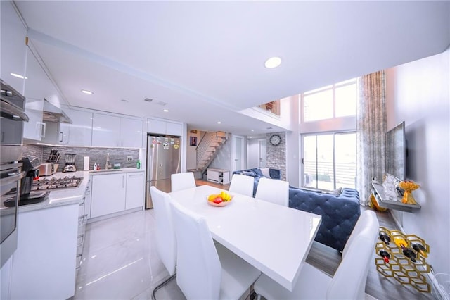2784 E 12th St Unit 3, Brooklyn, NY 11235 - dining space with stairway and recessed lighting
