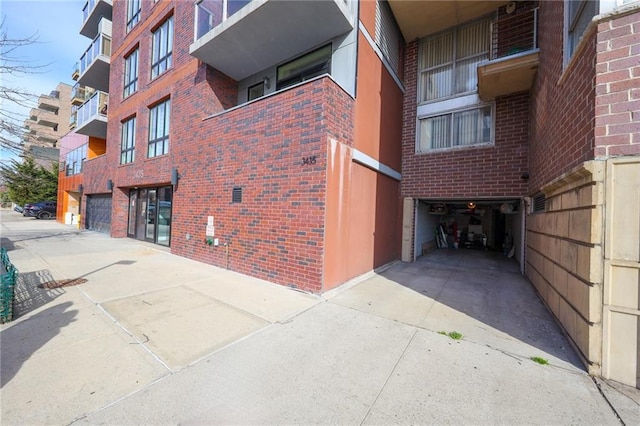 2784 E 12th St Unit 3, Brooklyn, NY 11235 - view of apartment building / complex featuring an attached garage and driveway