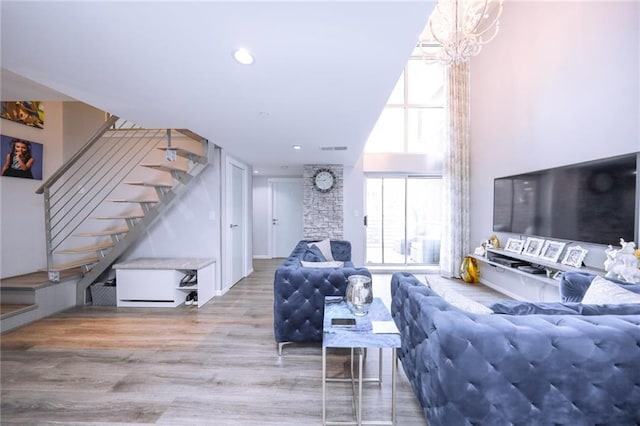 2784 E 12th St Unit 3, Brooklyn, NY 11235 - living area with stairs, a chandelier, wood finished floors, and recessed lighting