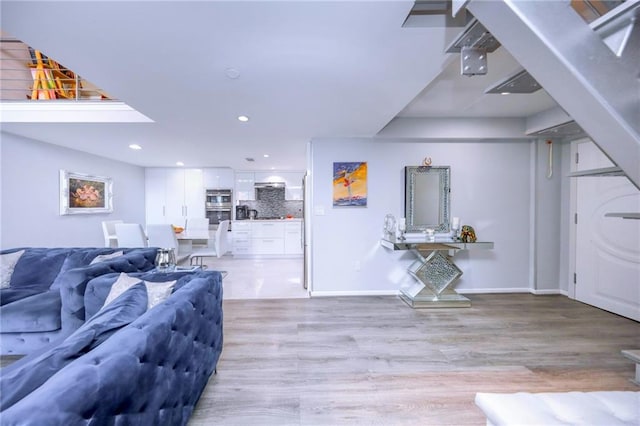 2784 E 12th St Unit 3, Brooklyn, NY 11235 - living area with light wood finished floors, recessed lighting, and baseboards