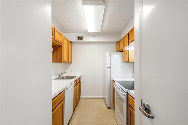 221 Bch 80th St Unit 4F, Rockaway Beach, NY 11693 - kitchen with white appliances, a sink, under cabinet range hood, light floors, and light countertops