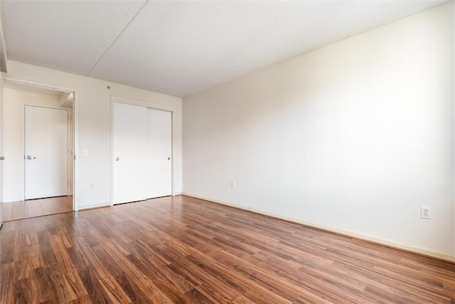 221 Bch 80th St Unit 4F, Rockaway Beach, NY 11693 - unfurnished bedroom with wood finished floors, a closet, and baseboards