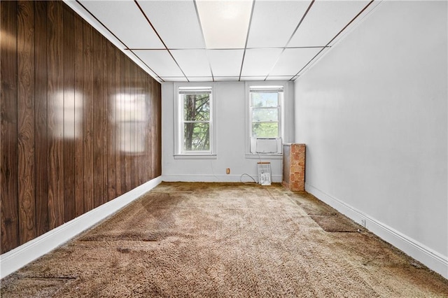 1640 W 1st St, Brooklyn, NY 11223 - carpeted spare room with baseboards, a drop ceiling, and wood walls