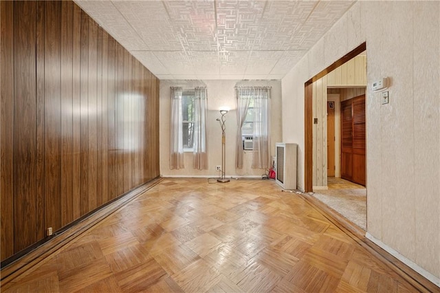 1640 W 1st St, Brooklyn, NY 11223 - spare room featuring baseboards, wooden walls, and cooling unit