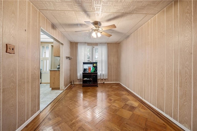 1640 W 1st St, Brooklyn, NY 11223 - empty room with ceiling fan, wooden walls, and baseboards