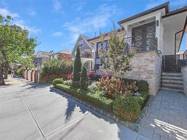 4906 21st Ave, East Elmhurst, NY 11370 - view of front of house with stone siding and a residential view