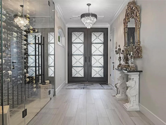 4906 21st Ave, East Elmhurst, NY 11370 - foyer featuring a chandelier, french doors, ornamental molding, baseboards, and wood finished floors
