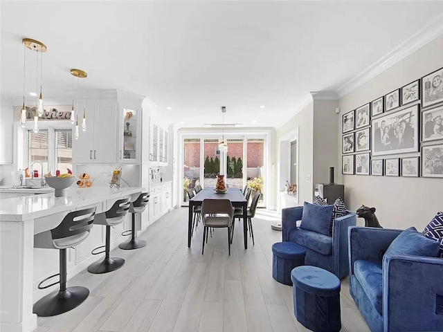 4906 21st Ave, East Elmhurst, NY 11370 - dining room featuring plenty of natural light, recessed lighting, crown molding, and light wood-style floors