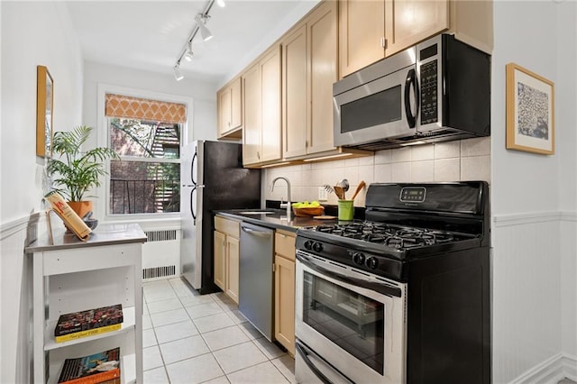 385 Argyle Rd Unit 4A, Brooklyn, NY 11218 - kitchen with stainless steel appliances, radiator heating unit, dark countertops, a wainscoted wall, and backsplash