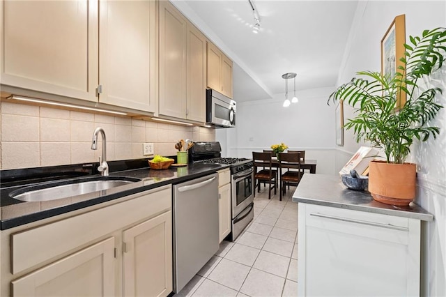 385 Argyle Rd Unit 4A, Brooklyn, NY 11218 - kitchen with appliances with stainless steel finishes, light tile patterned floors, tasteful backsplash, dark countertops, and decorative light fixtures
