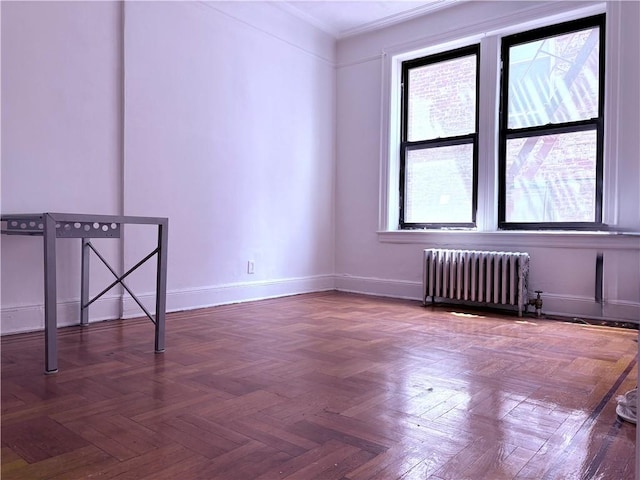 219 78th St Unit 2D, Brooklyn, NY 11209 - spare room with radiator heating unit, ornamental molding, and baseboards