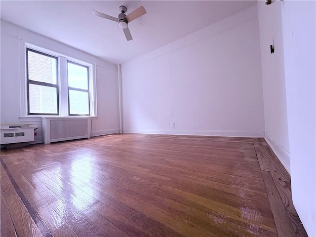 219 78th St Unit 2D, Brooklyn, NY 11209 - unfurnished room with radiator heating unit, wood finished floors, and ceiling fan