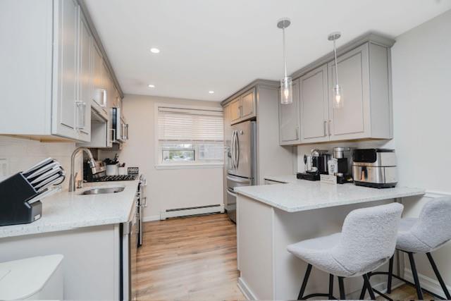 400 Maryland Ave Unit 2D, Staten Island, NY 10305 - kitchen featuring freestanding refrigerator, a baseboard radiator, gray cabinetry, a sink, and light wood-style floors