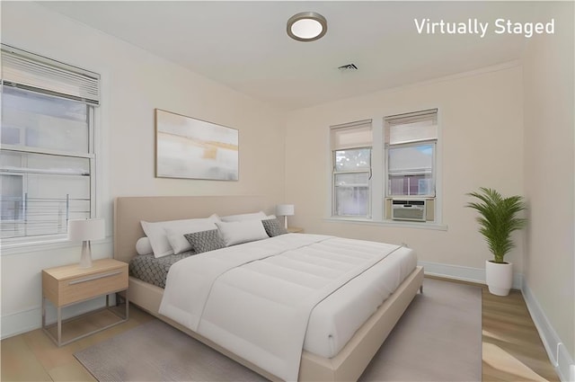 1206 E 9th St, Brooklyn, NY 11230 - bedroom featuring baseboards, wood finished floors, multiple windows, and cooling unit