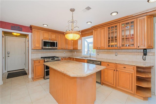 5 Haywood St, Staten Island, NY 10307 - kitchen with appliances with stainless steel finishes, a sink, a center island, light stone countertops, and light tile patterned floors